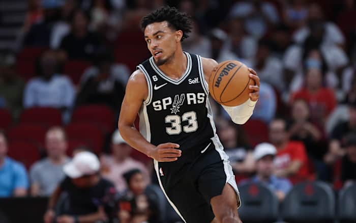 San Antonio Spurs point guard Tre Jones brings the ball up the floor.